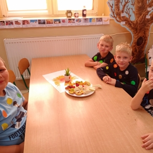 Czterech chłopców je owoce przy stoliku